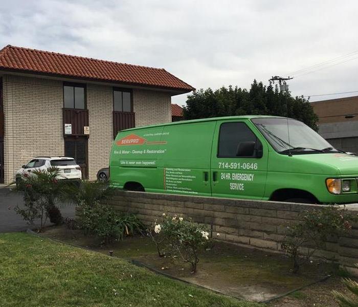 Picture of green van with company information