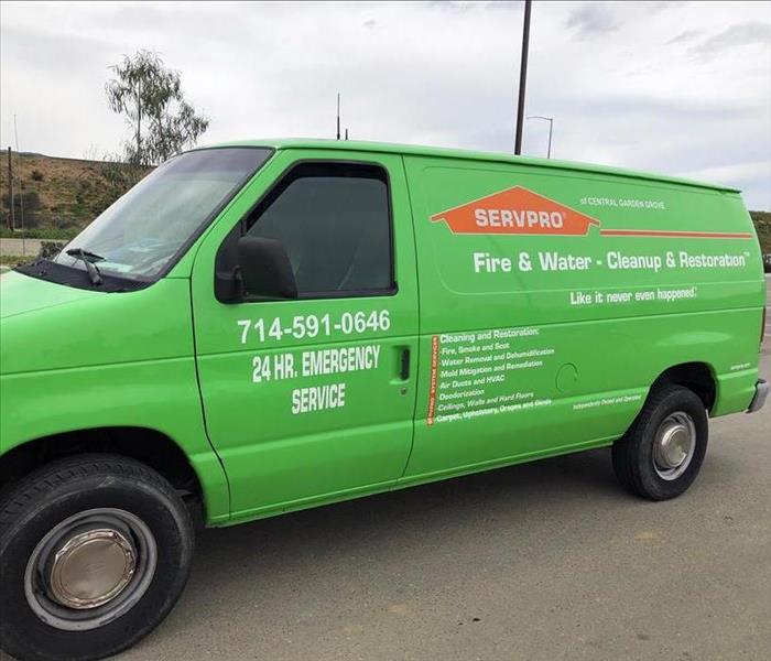 Picture of green commercial van on street.